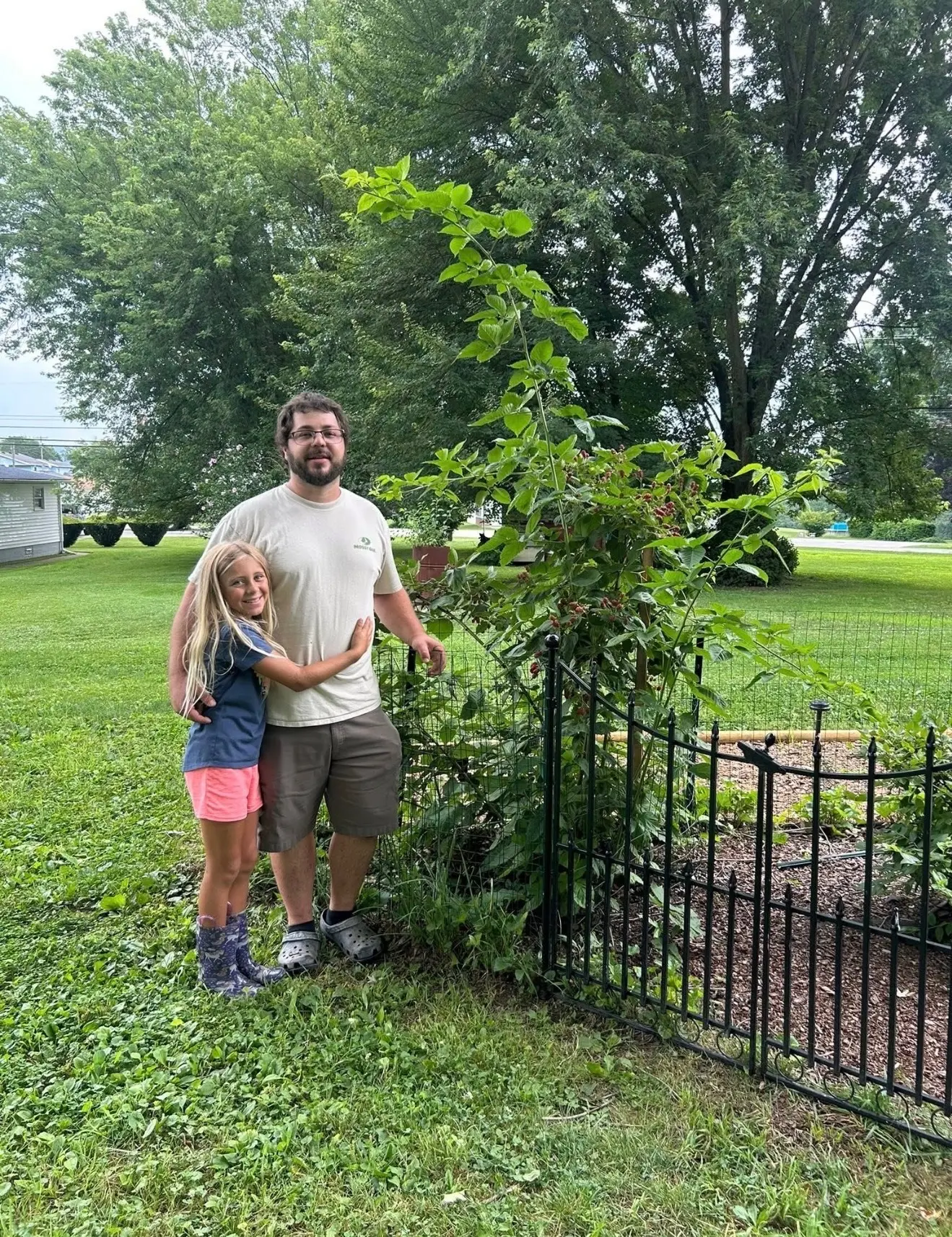 Tyler Mullen and daughter McKenzie beside their organic raspberry patch at The Sanctuberry in Latrobe, Pennsylvania